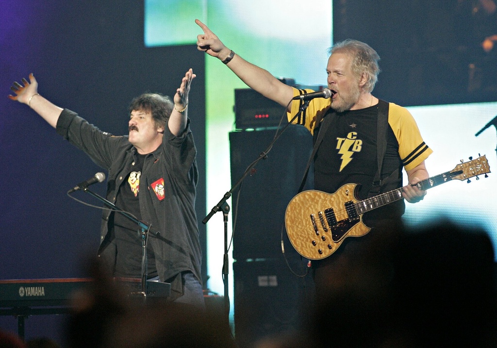 CONFIRMING PHOTOG WITH CP Burton Cummings and Randy Bachman, left, of The Guess Who acknowledge applause during a tribute at the Juno Awards in Winnipeg, April 3, 2005. (AP Photo/CP,Marianne Helm/The Canadian Press via AP)