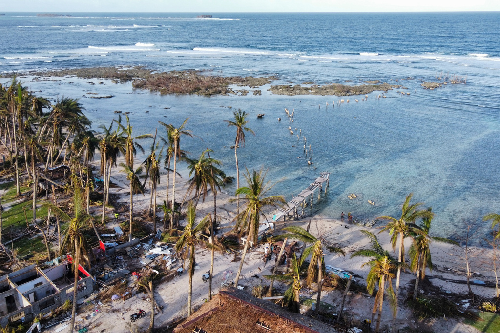 FILE -The remains of a damaged boardwalk caused by Typhoon Rai in Siargao island, Surigao del Norte, southern Philippines on, Dec. 22, 2021. (AP Photo/Alren Beronio, File)