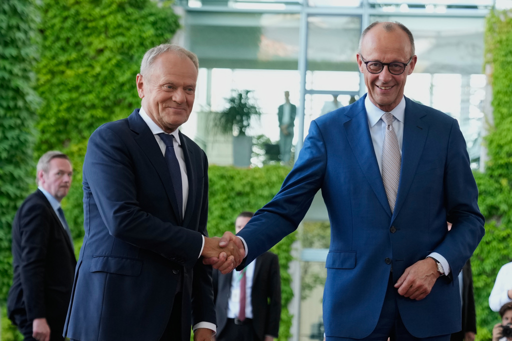 German Chancellor Friedrich Merz, right, welcomes Poland's Prime Minister Donald Tusk at the E5 NATO Summit in Berlin Germany, Wednesday, June 24, 2026. (AP Photo/Ebrahim Noroozi)