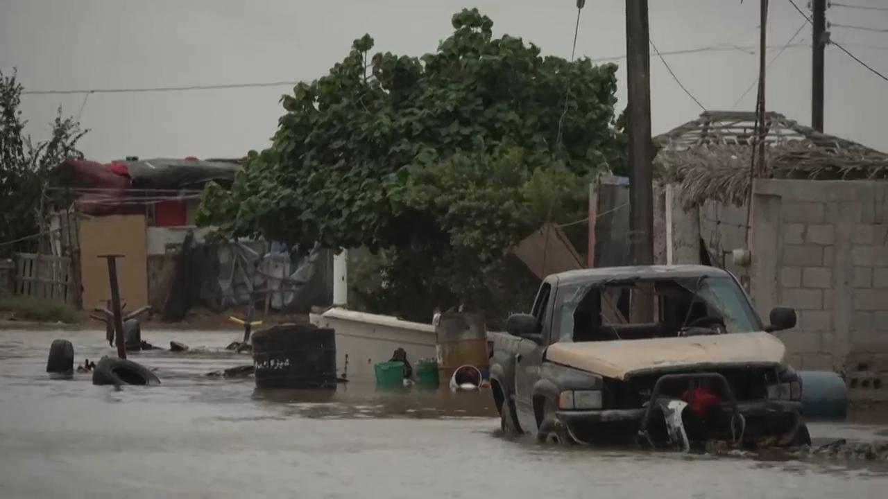Floodwaters swept through streets in a fishing town on Mexico's Baja California peninsula Monday as Hurricane Polo bore down on the region. (AP video: Mart&iacute;n Silva Rey)