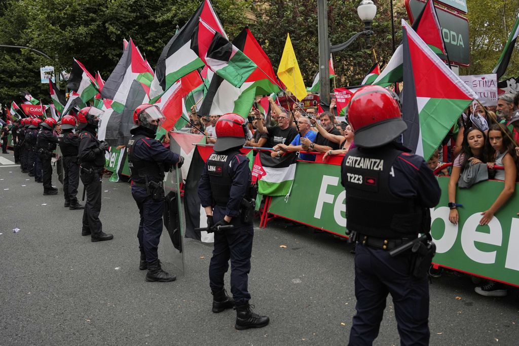 People hold Palestinian flags during the eleventh stage of the Spanish Vuelta cycling race, from Bilbao to Bilbao, Spain, Wednesday, Sept. 3, 2025. (AP Photo/Miguel Oses)