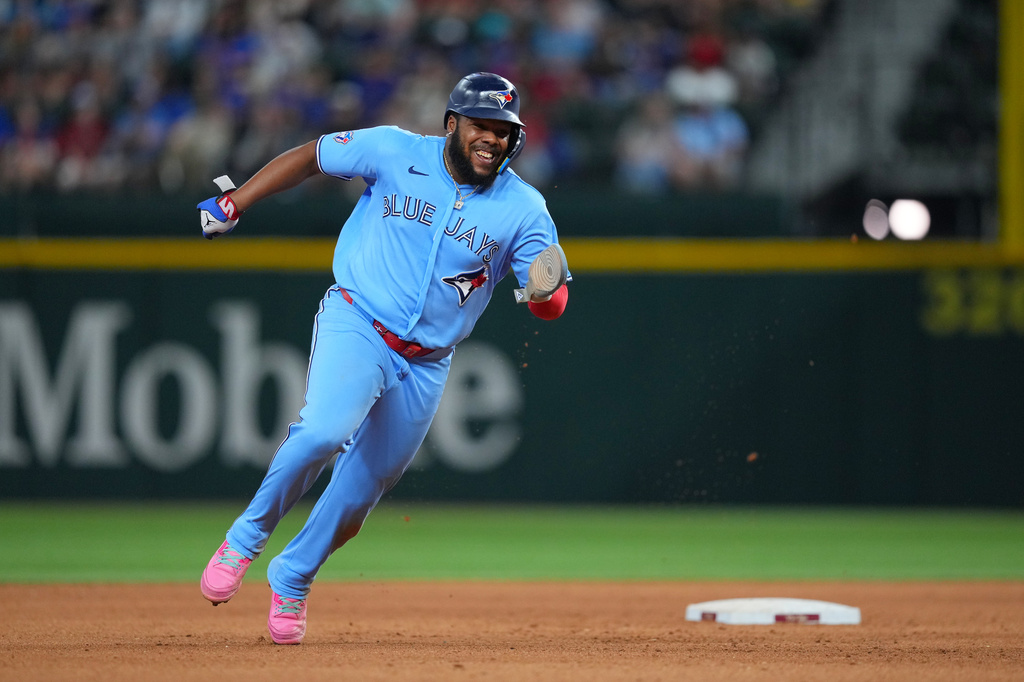 Toronto Blue Jays first baseman Vladimir Guerrero Jr. runs from first to third base on a hit by teammate Alejandro Kirk against the Texas Rangers during the eighth inning of a baseball game Saturday, Sept. 19, 2026, in Arlington, Texas. (AP Photo/Julio Cortez)