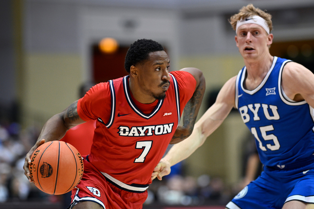 Dayton forward Keonte Jones (7) drives past BYU guard Richie Saunders (15) during the second half of an NCAA college basketball game, Friday, Nov. 28, 2025, in Kissimmee, Fla. (AP Photo/Phelan M. Ebenhack)