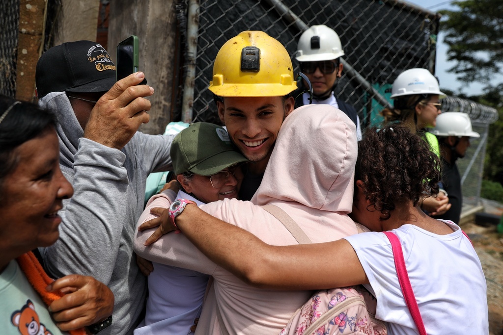 A miner embraces family members after he was rescued from a gold mine that collapsed, in Segovia, Colombia, Wednesday, Sept. 24, 2025. (AP Photo/Santiago Saldarriaga)