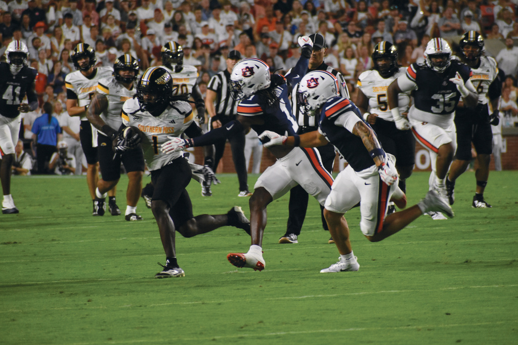Southern Miss Wide Receiver Mario Sanders runs away from Auburn defenders during an NCAA College Football game Saturday, Sept. 12, 2026 in Auburn, Al. (Aimee Cronan/The Gazebo Gazette via AP)