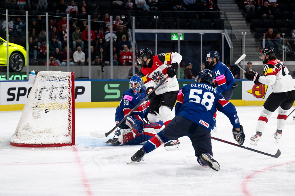 Austria's Peter Schneider, 2nd from left, scores his side's fourth goal past Britain's goaltender Mat Robson, during the 2026 IIHF Men's Ice Hockey World Championship preliminary round group A game between Britain and Austria, in Zurich, Switzerland, Saturday, May 16, 2026. (Andreas Becker/Keystone via AP)