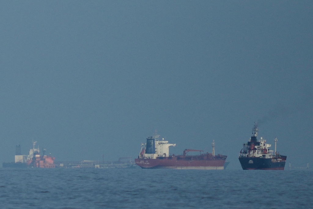 Oil tankers and cargo ships line up in the Strait of Hormuz as seen from Khor Fakkan, United Arab Emirates, Wednesday, March 11, 2026. (AP Photo/Altaf Qadri)