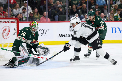 Minnesota Wild goaltender Jesper Wallstedt, left, makes a save against a shot by Los Angeles Kings center Alex Turcotte, front left, during the second period of an NHL hockey game Monday, Oct. 13, 2025, in St. Paul, Minn. (AP Photo/Matt Krohn) Minnesota Wild goaltender Jesper Wallstedt, left, makes a save against a shot by Los Angeles Kings center Alex Turcotte, front left, during the second period of an NHL hockey game Monday, Oct. 13, 2025, in St. Paul, Minn. (AP Photo/Matt Krohn)