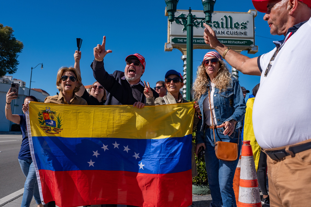 People celebrate outside Versailles Cuban Cuisine after President Donald Trump announced Venezuelan President Nicolás Maduro had been captured and flown out of the country, in Miami, Saturday, Jan. 3, 2026. (AP Photo/Jen Golbeck)