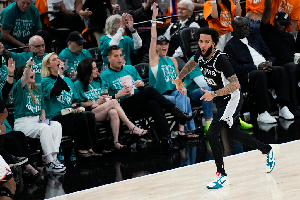 San Antonio Spurs forward Julian Champagnie (30) celebrates a basket against the New York Knicks during the first half of Game 1 of the NBA Finals basketball series, Wednesday, June 3, 2026, in San Antonio. (AP Photo/David J. Phillip)