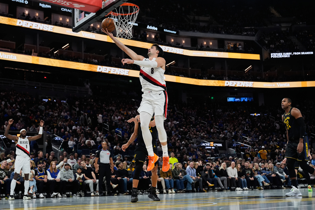 Portland Trail Blazers forward Deni Avdija (8) shoots next to Golden State Warriors guard Stephen Curry (30) during the first half of an NBA Cup basketball game, Friday, Nov. 21, 2025, in San Francisco. (AP Photo/Godofredo A. Vásquez)