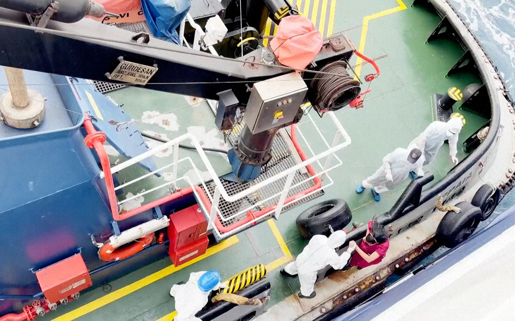 Health workers get off the Dutch-flagged MV Hondius, a cruise ship carrying nearly 150 people as it remains off Cape Verde on Monday, May 4, 2026 after three passengers died and several others fell seriously ill in a suspected hantavirus outbreak. (Qasem Elhato via AP)