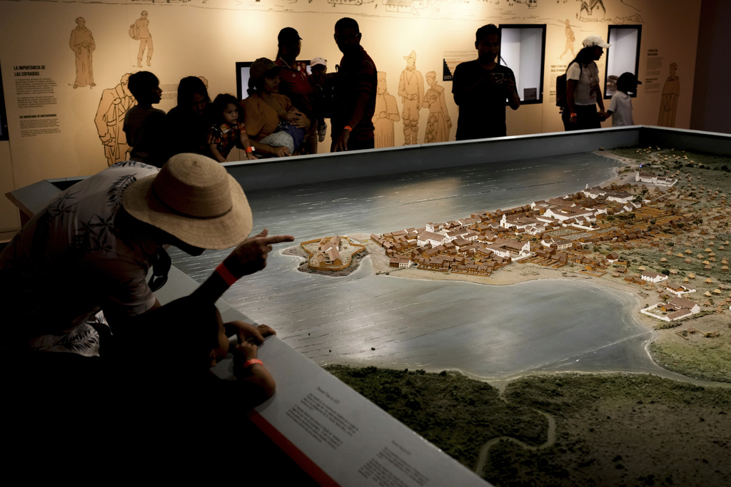 Tourists at the Old Panama Museum look at a topical map of Panama City's first colonial settlement, founded in 1519, in Panama City, Friday, Aug. 15, 2025. (AP Photo/Matias Delacroix)