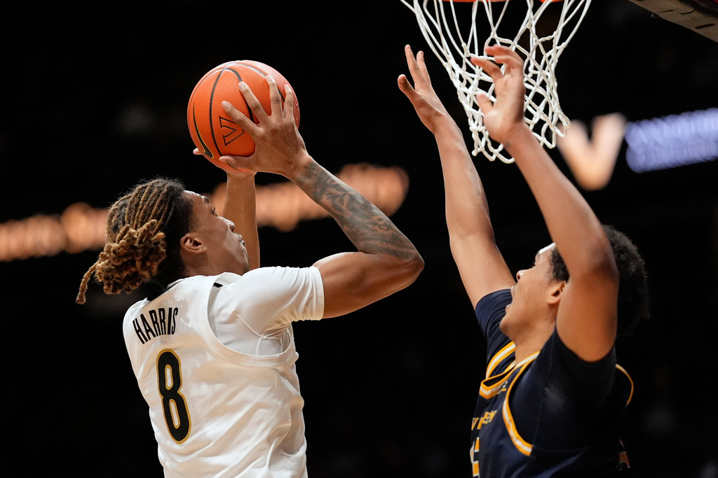 Vanderbilt guard Tyler Harris (8) shoots the ball past New Haven forward Andre Pasha, right, during the first half of an NCAA college basketball game Monday, Dec. 29, 2025, in Nashville, Tenn. (AP Photo/George Walker IV)
