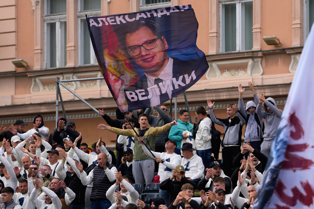Supporters wave a flag shows Serbia's populist leader Aleksandar Vucic during a pre-election rally of the ruling Serbian Progressive Party (SNS) ahead of early parliamentary elections in Novi Sad, Serbia, Friday, Oct. 16, 2026. (AP Photo/Darko Vojinovic)