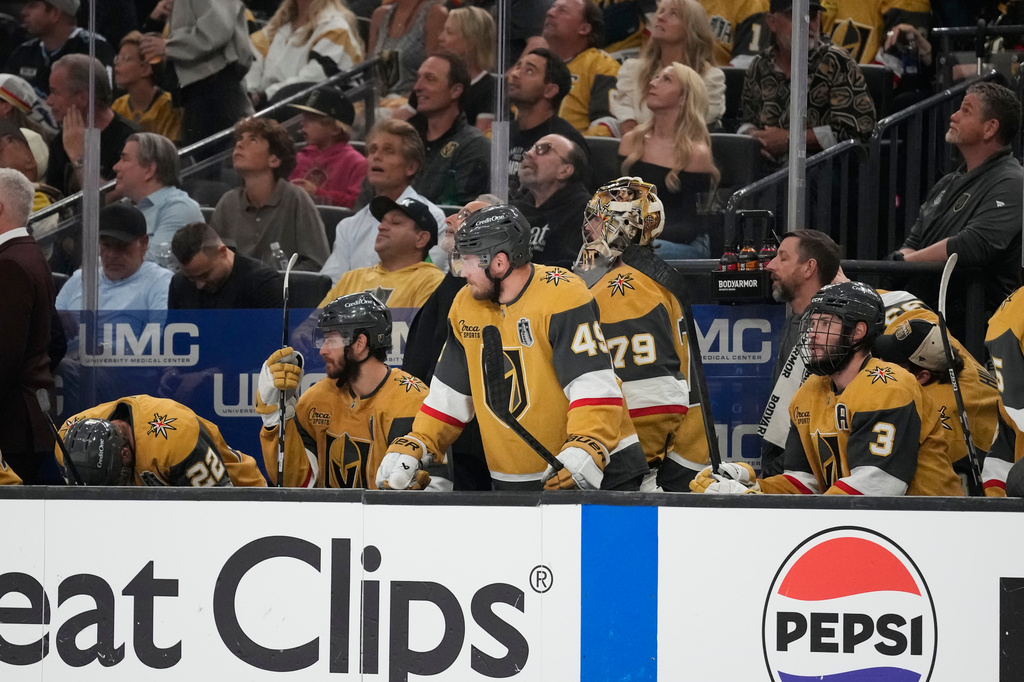 Vegas Golden Knights players watch from the bench during the third period in Game 6 of the NHL hockey Stanley Cup Final series against the Carolina Hurricanes, Sunday, June 14, 2026, in Las Vegas. (AP Photo/John Locher)