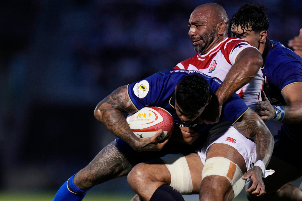 Italy's Monty Ioane, left, is tackled by Japan's Michael Leitch during the Nations Championship rugby match between Japan and Italy in Tokyo, Saturday, July 4, 2026. (AP Photo/Shuji Kajiyama)