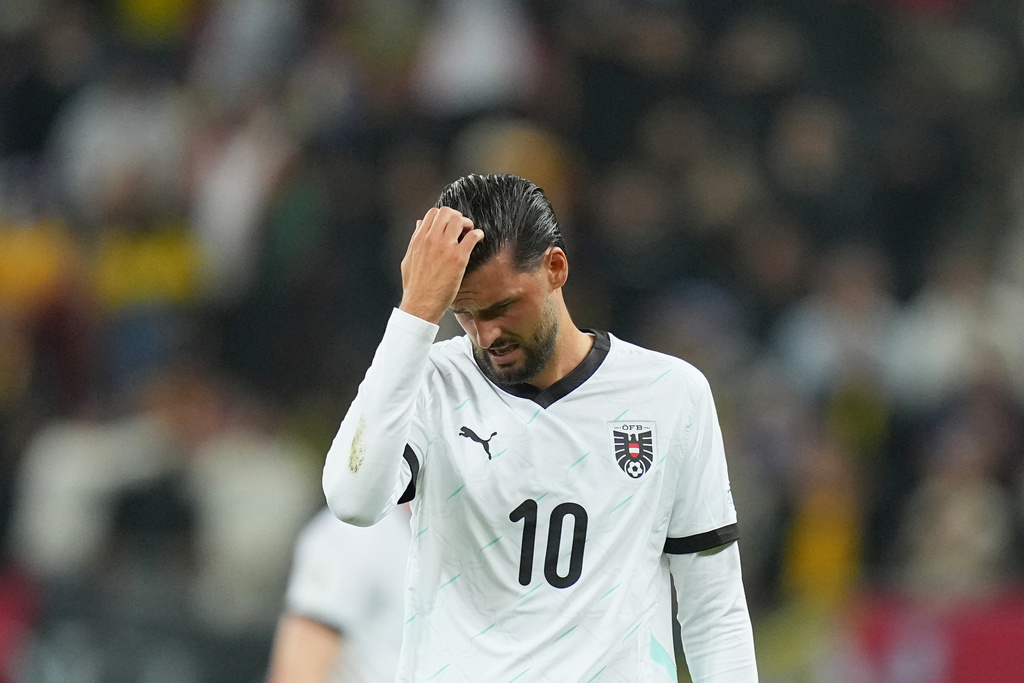 Austria's Florian Grillitsch is dejected after the World Cup 2026 group H qualifying soccer match between Romania and Austria at the National Arena stadium, in Bucharest, Romania, Sunday, Oct. 12, 2025. (AP Photo/Andreea Alexandru)