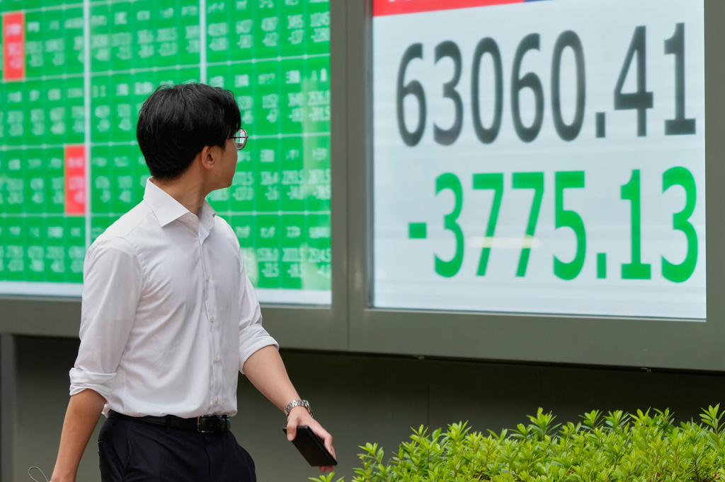 A person walks in front of an electronic stock board showing Japan's Nikkei index at a securities firm Friday, July 17, 2026, in Tokyo. (AP Photo/Eugene Hoshiko)