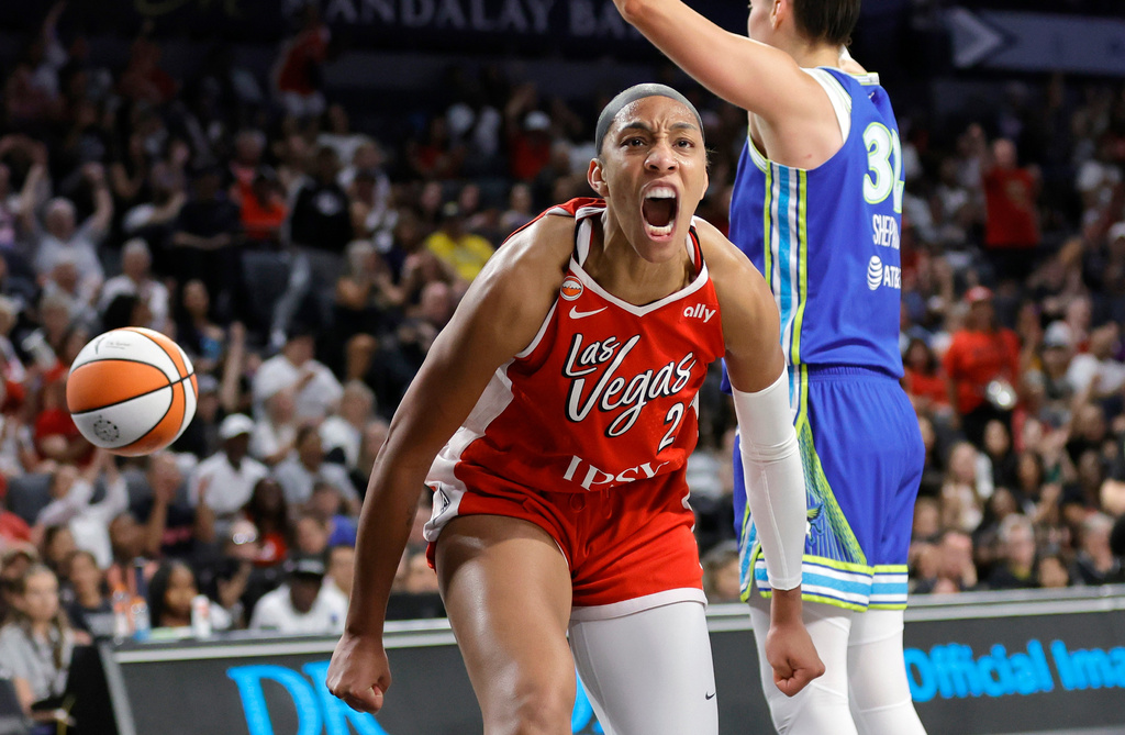 Las Vegas Aces center A'ja Wilson, left, reacts after scoring against Dallas Wings forward Jessica Shepard, right, during the first half of a WNBA basketball game Thursday, June 25, 2026, in Las Vegas. (Steve Marcus/Las Vegas Sun via AP)