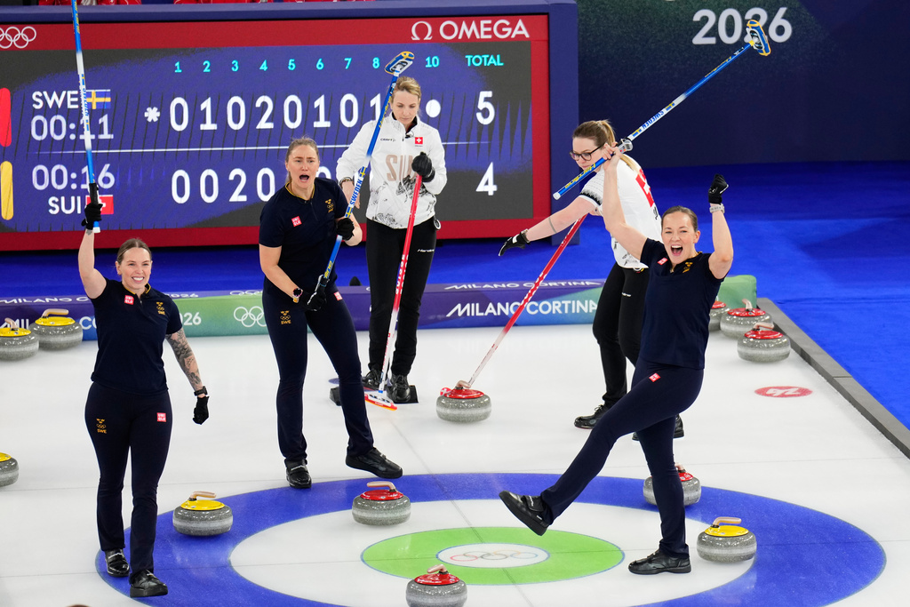 Sweden's Sara McManus, Agnes Knochenhauer and Sofia Scharback celebrate after beating Switzerland during a women's curling round robin match at the 2026 Winter Olympics, in Cortina d'Ampezzo, Italy, Monday, Feb. 16, 2026. (AP Photo/David J. Phillip)