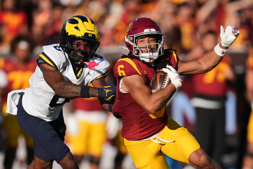 Southern California wide receiver Makai Lemon (6) runs past Michigan defensive back Brandyn Hillman (6) during the first half of an NCAA college football game Saturday, Oct. 11, 2025, in Los Angeles. (AP Photo/Marcio Jose Sanchez)