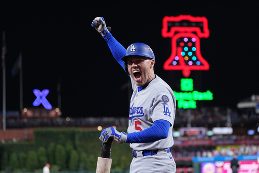 Los Angeles Dodgers' Freddie Freeman reacts after Teoscar Hernández hit a three-run home run off Philadelphia Phillies pitcher Matt Strahm during the seventh inning in Game 1 of baseball's National League Division Series, Saturday, Oct. 4, 2025, in Philadelphia. (AP Photo/Matt Rourke) Los Angeles Dodgers' Freddie Freeman reacts after Teoscar Hernández hit a three-run home run off Philadelphia Phillies pitcher Matt Strahm during the seventh inning in Game 1 of baseball's National League Division Series, Saturday, Oct. 4, 2025, in Philadelphia. (AP Photo/Matt Rourke)