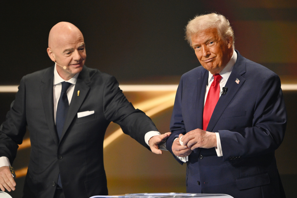 FIFA President Gianni Infantino pauses President Donald Trump during the draw for the 2026 soccer World Cup at the Kennedy Center in Washington, Friday, Dec. 5, 2025. (Mandel Ngan/Pool Photo via AP)
