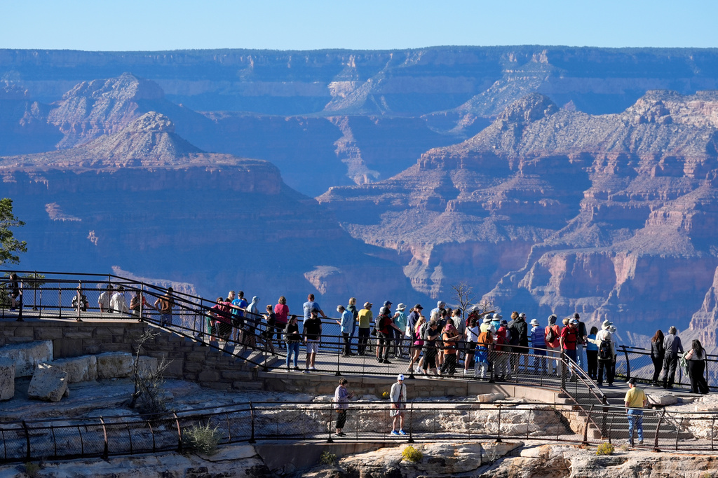 FILE - Tourists flock to Mather Point at Grand Canyon National Park, Oct. 1, 2025, in Grand Canyon, Ariz. (AP Photo/Ross D. Franklin, File)