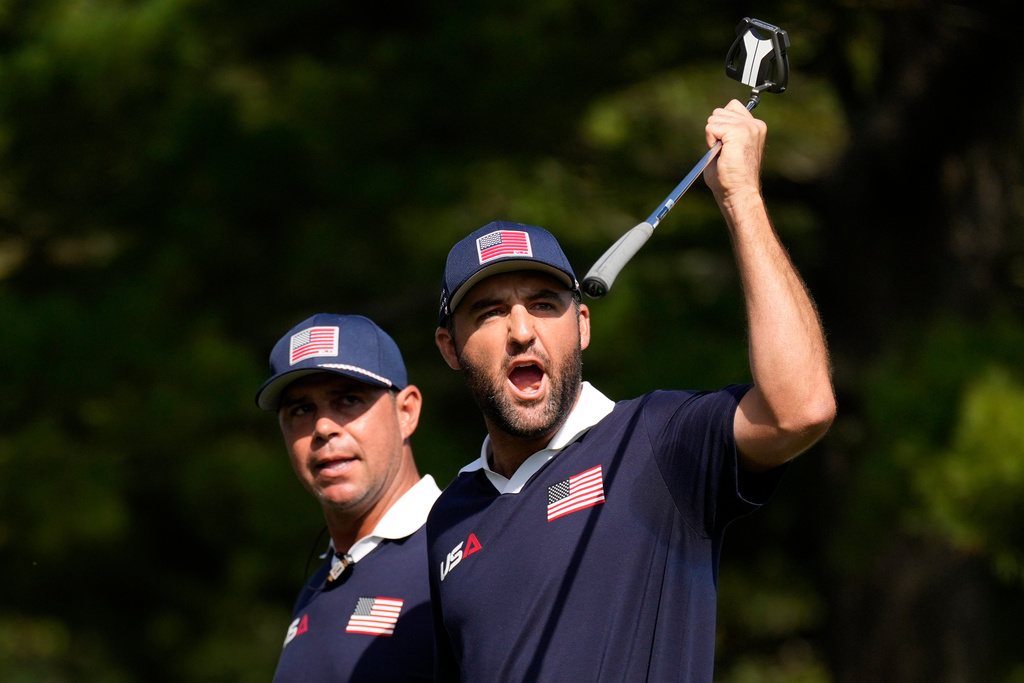 United States' Scottie Scheffler celebrates after a putt on the 13th hole at Bethpage Black golf course during the Ryder Cup golf tournament, Saturday, Sept. 27, 2025, in Farmingdale, N.Y. (AP Photo/Seth Wenig)
