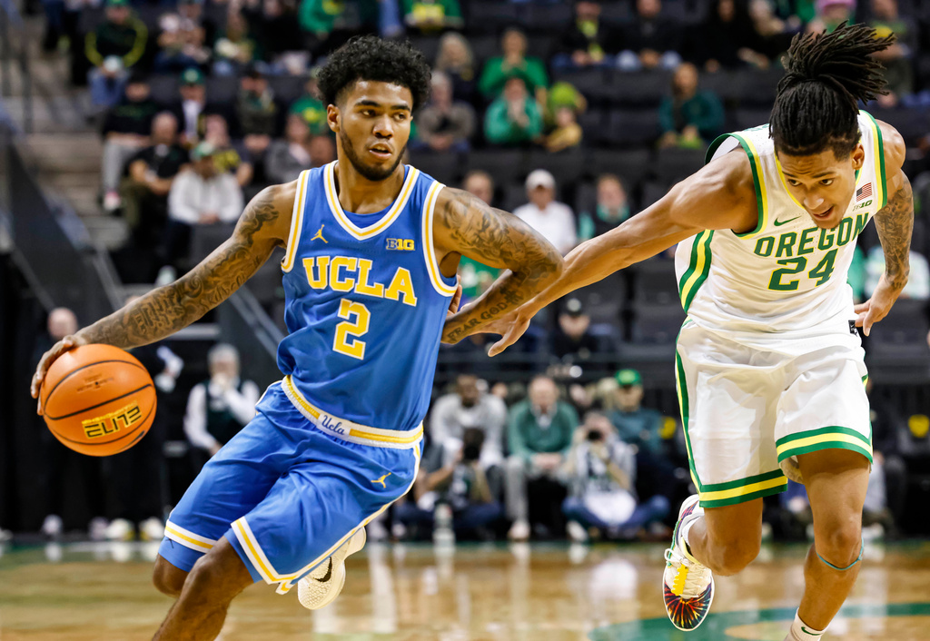 UCLA guard Donovan Dent (2) drives against Oregon guard Jamari Phillips (24) in the second half of an NCAA college basketball game in Eugene, Ore., Wednesday, Jan. 28 2026. (AP Photo/Thomas Boyd)