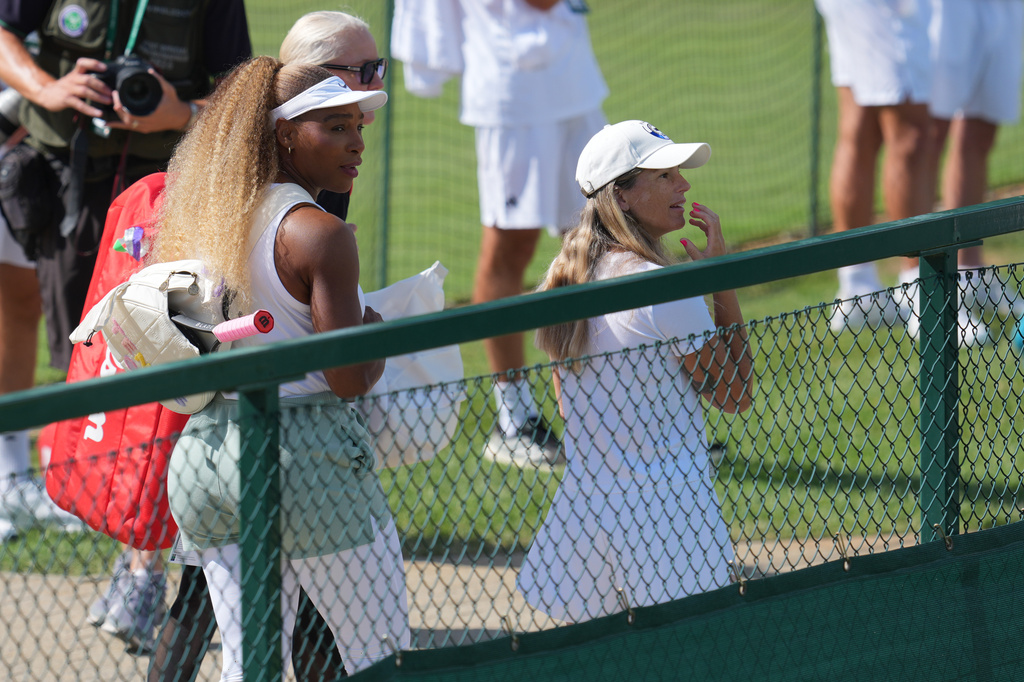 Serena Williams of the United States, left, arrives to practice one day ahead of the start of the Wimbledon Tennis Championships in London, Sunday, June 28, 2026. (AP Photo/Kin Cheung)