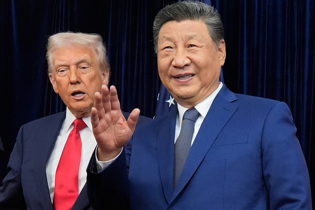 FILE- Chinese President Xi Jinping, right, waves, with President Donald Trump, ahead of their summit talk at Gimhae International Airport in Busan, South Korea, Thursday, Oct. 30, 2025. (AP Photo/Mark Schiefelbein, File)