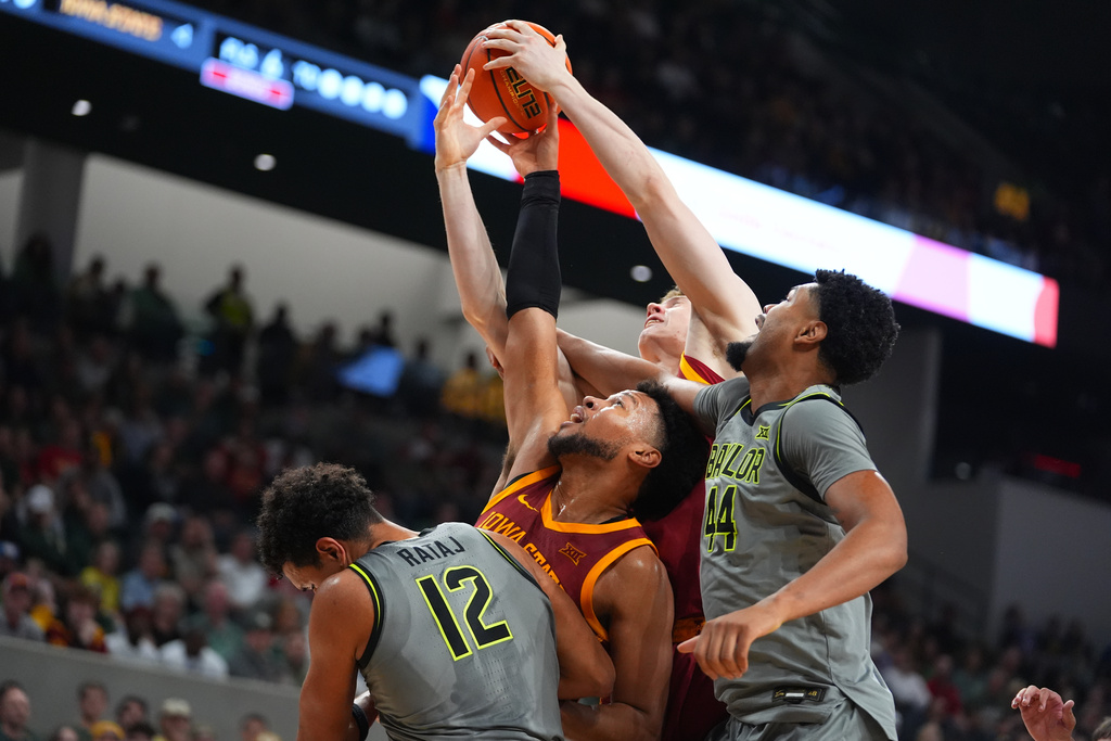 Baylor guard Michael Rataj (12) and center Caden Powell (44) compete for a rebound against Iowa State forward Joshua Jefferson, center, left, and forward Dominykas Pleta during the first half of an NCAA college basketball game Wednesday, Jan. 7, 2026, in Waco, Texas. (AP Photo/Julio Cortez)
