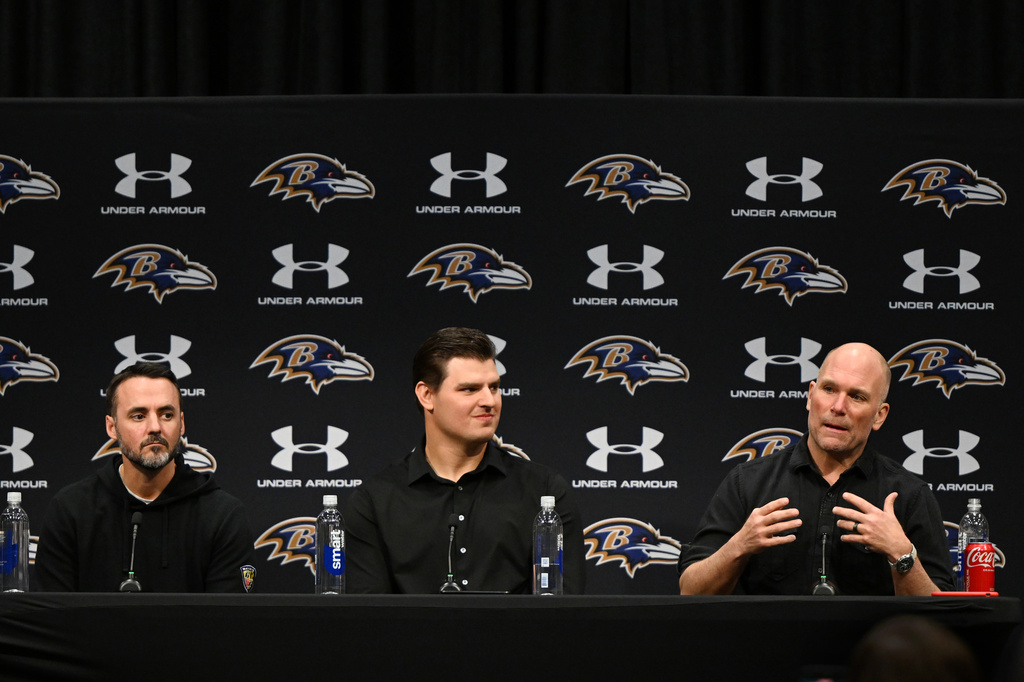 Baltimore Ravens general manager Eric DeCosta, right, speaks as defensive end Trey Hendrickson, center, and head coach Jesse Minter look on during an NFL football press conference Friday, March 13, 2026, in Owings Mills, Md. (AP Photo/Gail Burton)