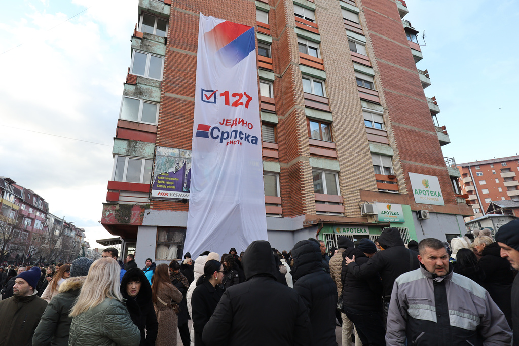 Supporters of Belgrade-backed Srpska Lista prepare to go at a polling station and cast their ballots in an early parliamentary election in the northern Serb-dominated part of ethnically divided town of Mitrovica, Kosovo, Sunday, Dec. 28, 2025. (AP Photo/Bojan Slavkovic)