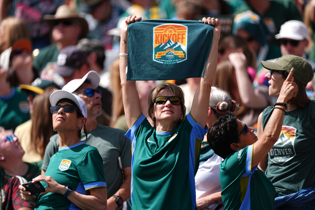 A fan holds up a towel for Denver Summit FC in the first half of an NWSL soccer match against the Washington Spirit, Saturday, March 28, 2026, in Denver. (AP Photo/David Zalubowski)