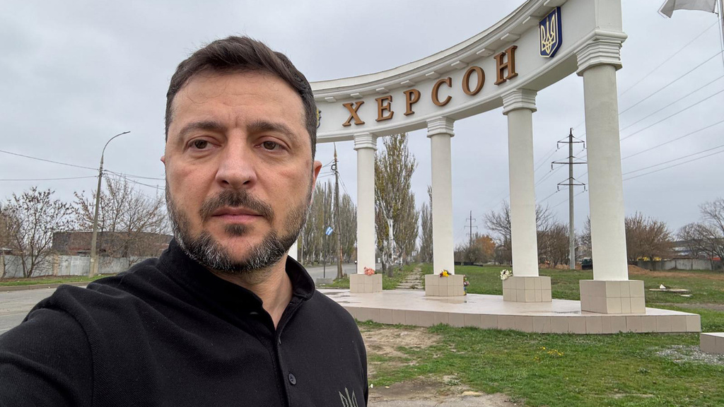 In this photo provided by the Ukrainian Presidential Press Office, Ukrainian President Volodymyr Zelenskyy stands at the sign reading "Kherson" at the approaches to the front line city of Kherson, Southern Ukraine, Tuesday, Nov. 11, 2025. (Ukrainian Presidential Press Office via AP)
