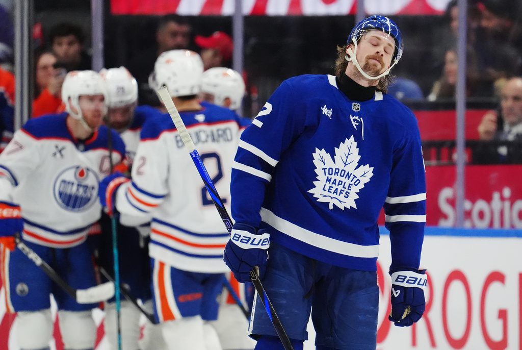 Toronto Maple Leafs' Simon Benoit (2) reacts as Edmonton Oilers players celebrate a goal during the second period of an NHL hockey game in Toronto on Saturday, Dec. 13, 2025. (Frank Gunn/The Canadian Press via AP)