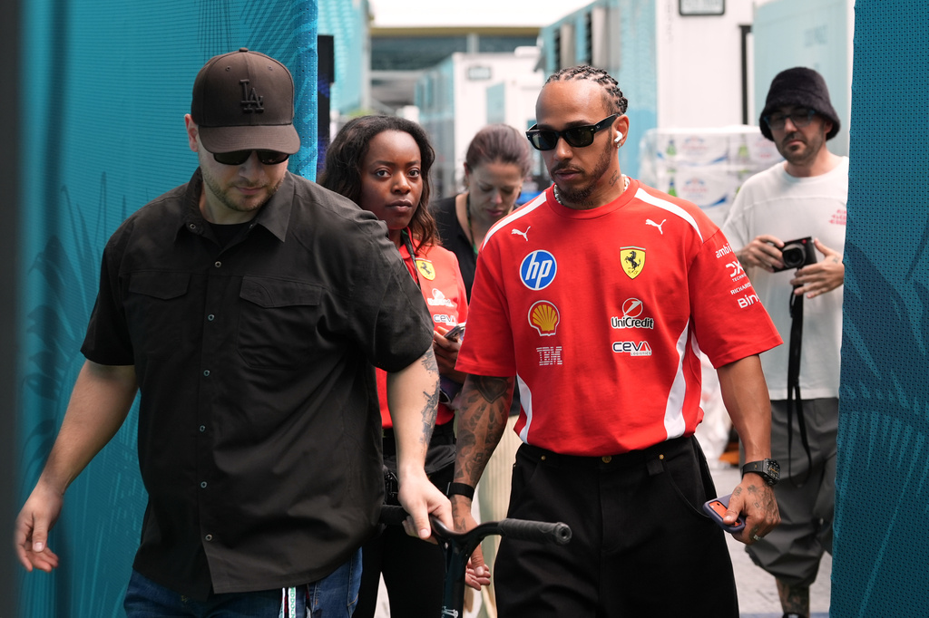 Ferrari driver Lewis Hamilton, center right, of Britain, leaves a hospitality tent after speaking to the press, Thursday, April 30, 2026, in Miami Gardens, Fla., ahead of the Formula One Miami Grand Prix auto race. (AP Photo/Rebecca Blackwell)