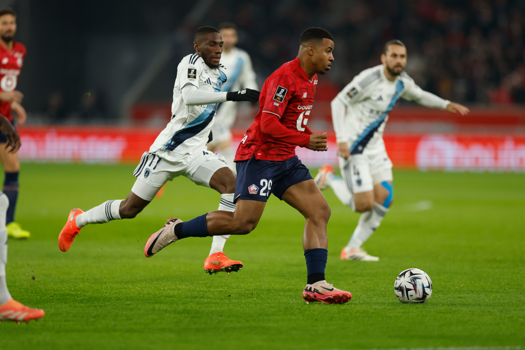 Lille's Igamane Hamza, front, plays the ball during the French League One soccer match between Lille and Paris FC in Lille, France, Sunday Nov. 23, 2025. (AP Photo/Jean-Francois Badias)