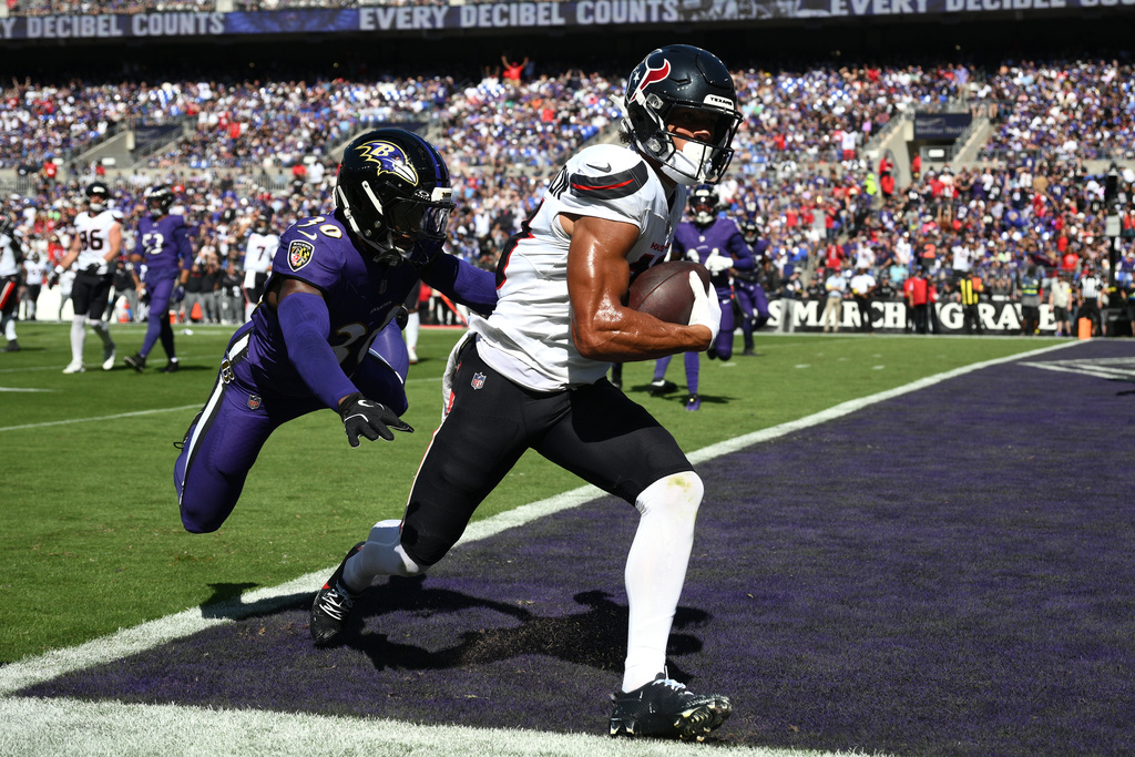 Houston Texans wide receiver Xavier Hutchinson (19) scores a touchdown during the first half of an NFL football game against the Baltimore Ravens, Sunday, Oct. 5, 2025, in Baltimore. (AP Photo/Nick Wass)
