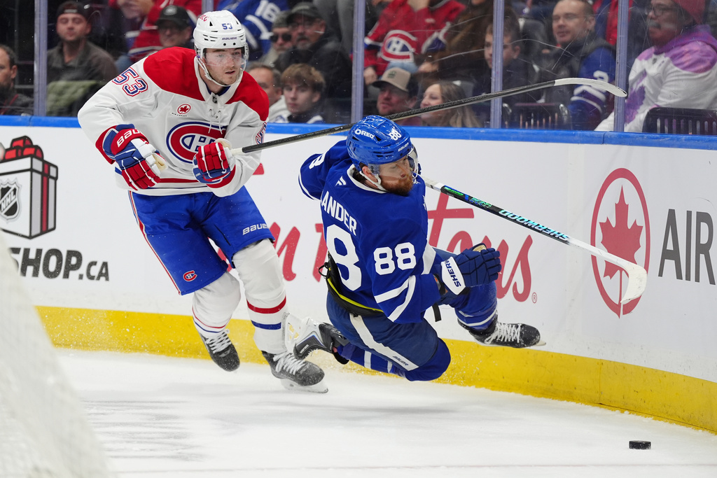 Montréal Canadiens defenceman Noah Dobson (53) picks up a penalty for tripping Toronto Maple Leafs right wing William Nylander (88) during second period NHL hockey action in Toronto on Saturday, Dec. 6, 2025. (Frank Gunn/The Canadian Press via AP)