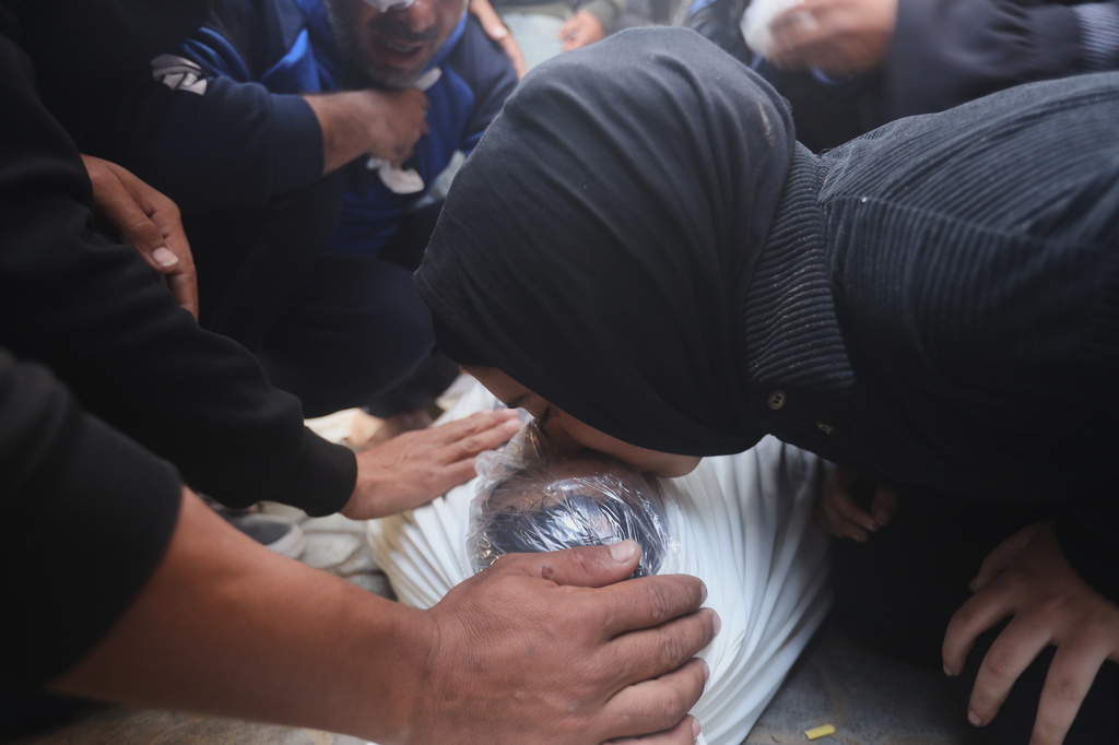 Palestinians mourn over Al-Tanani family members killed in an Israeli strike, during their funeral at Al-Shifa Hospital in Gaza City, Saturday, April 25, 2026. (AP Photo/Yousef Alzanoun)