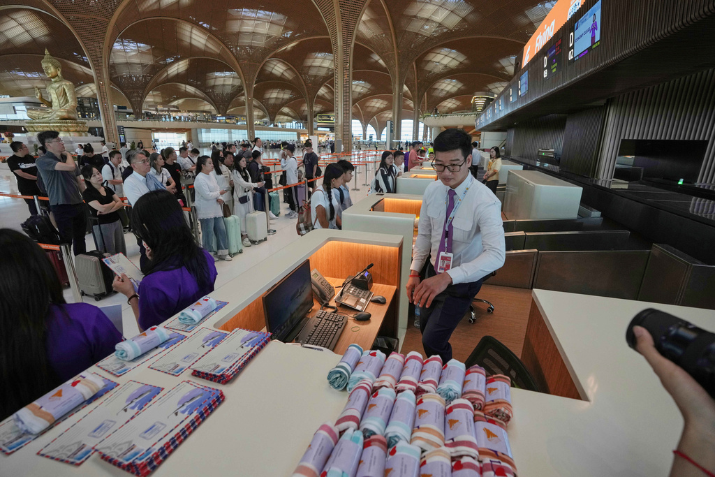 Passengers line up to check-in for their flights at the Techo International Airport on the outskirts of Phnom Penh, Cambodia, Tuesday, Sept. 9,2025. (AP Photo/Heng Sinith)