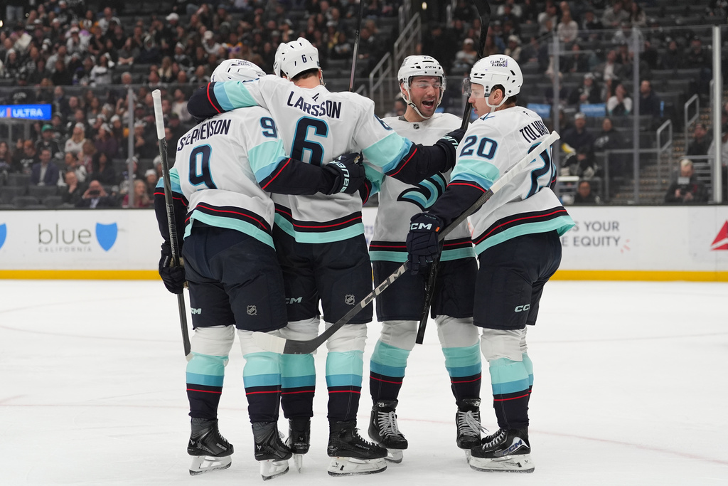 Seattle Kraken defenseman Adam Larsson (6) celebrates his goal with teammates during the first period of an NHL hockey game against the Los Angeles Kings Wednesday, Feb. 4, 2026, in Los Angeles. (AP Photo/Jae C. Hong)