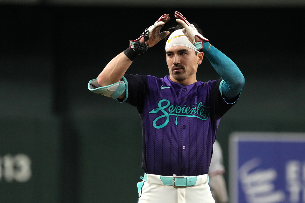 Arizona Diamondbacks' Corbin Carroll reacts after hitting a three-run triple against the Minnesota Twins in the eighth inning of a baseball game, Friday, June 19, 2026, in Phoenix. (AP Photo/Rick Scuteri)