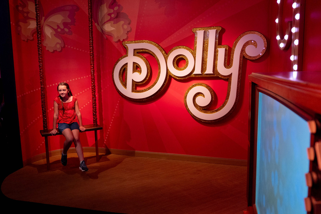 Kennedy Ojala sits in a Dolly Parton exhibit at the Dollywood theme park in Pigeon Forge, Tenn., Wednesday, Aug. 26, 2026. (AP Photo/Camden Hall)