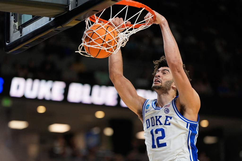 Duke forward Cameron Boozer dunks against TCU during the second half in the second round of the NCAA college basketball tournament, Saturday, March 21, 2026, in Greenville, S.C. (AP Photo/Chris Carlson)