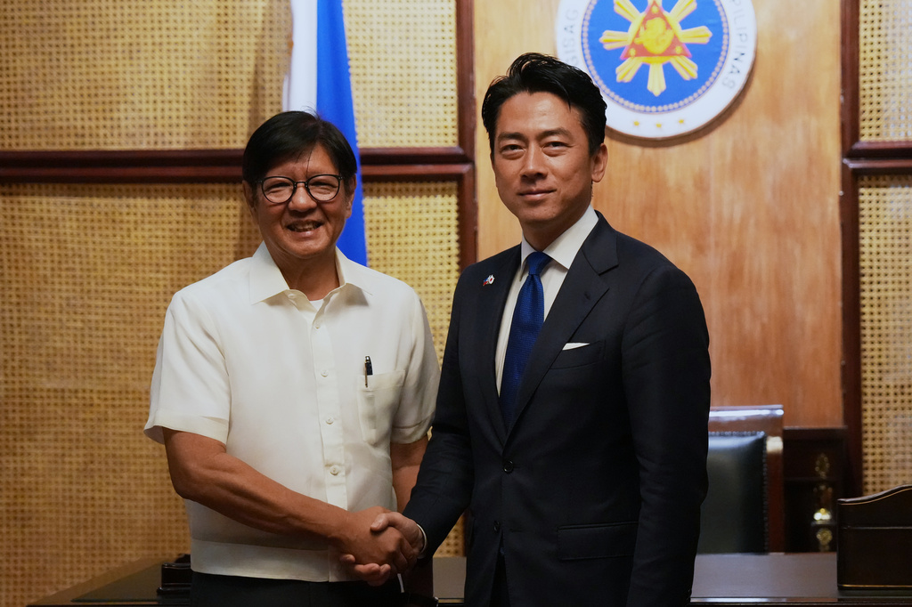 Philippine President Ferdinand Marcos Jr., left, greets Japan's Defense Minister Shinjiro Koizumi at the Malacanang presidential palace in Manila, Philippines on Tuesday, May 5, 2026. (AP Photo/Aaron Favila, Pool)